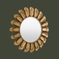Elegant circular mirror with layered gold metallic petals and contemporary styling.