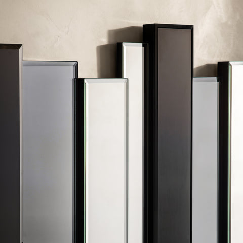 Detailed view of contemporary wall decor with alternating mirrored and black vertical panels.