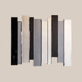 Decorative modern mirror installation with staggered vertical panels on a neutral background.