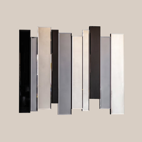 Decorative modern mirror installation with staggered vertical panels on a neutral background.