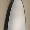 Close-up of a round black framed mirror