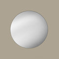 Round black mirror on a beige wall