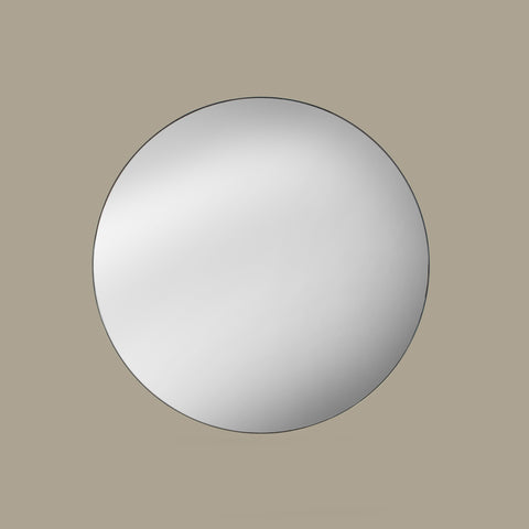 Round black mirror on a beige wall