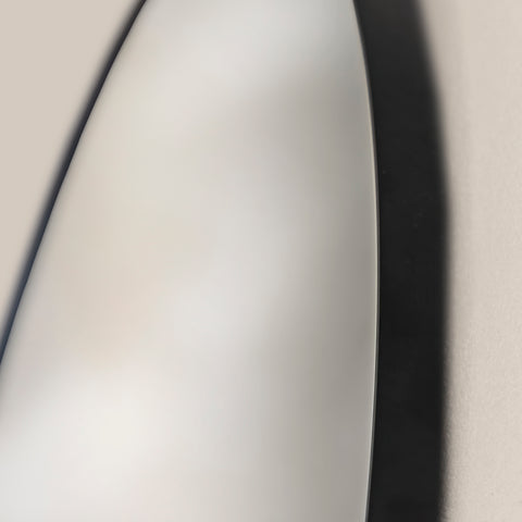  close-up of round wall mirror in black