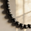 Luxury mirror frame detail with rounded gold embellishments and elegant metallic finish.