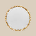Statement circular wall mirror with gold ball accents and elegant contemporary aesthetic.