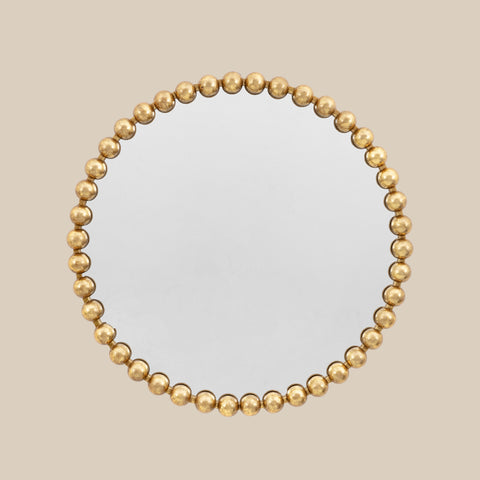 Statement circular wall mirror with gold ball accents and elegant contemporary aesthetic.