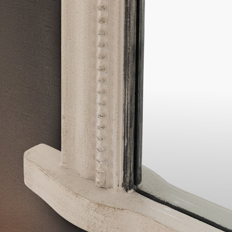 Macro view of a traditional grey mirror frame highlighting fine beaded detailing and distressed edges.