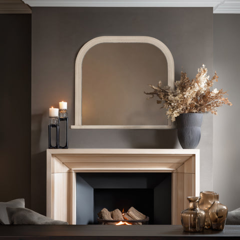 Classic arched statement mirror with soft curved edges positioned above a contemporary mantelpiece.