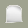Decorative white mirror frame detail with elegant beading and softly weathered texture