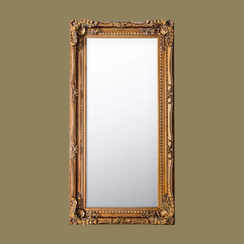 Large ornate full-length wall mirror with an antique gold carved frame featuring intricate baroque detailing against a neutral background.