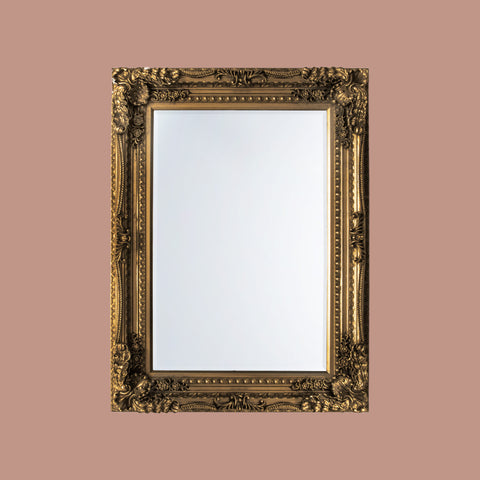 Decorative baroque-inspired mirror with an ornate gold frame and classic timeless styling.