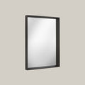 Rectangular mirror with black frame on a light gray background