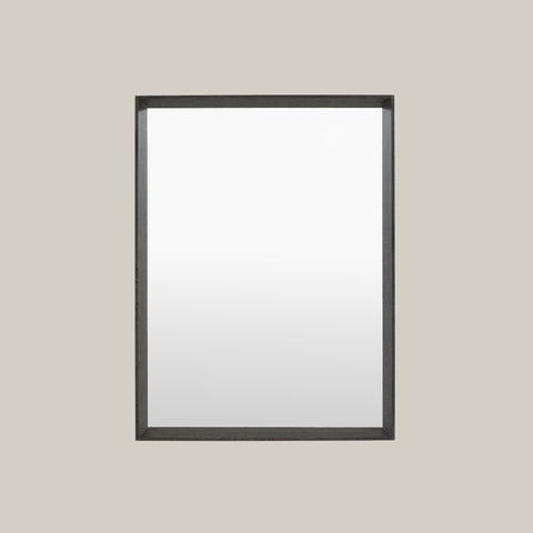 Black-framed mirror on a gray background
