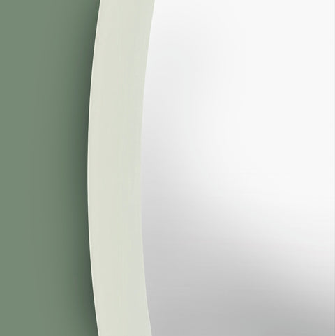 Contemporary circular wall mirror with smooth white trim and understated minimalist aesthetic.