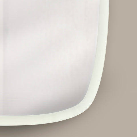 Close-up of a sleek white framed mirror featuring soft organic curves and understated design.