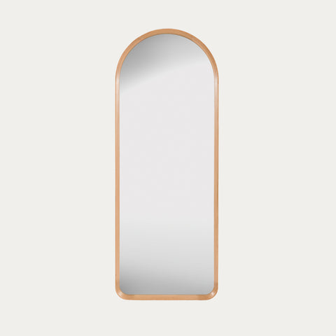 leaner mirror with a oak frame on a light grey background