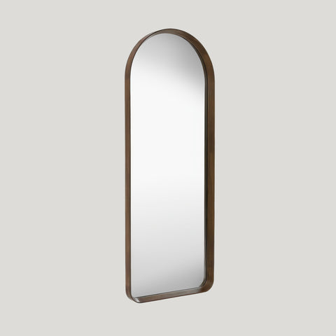 Large arched walnut leaner mirror on a soft grey background