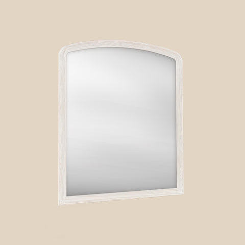 White wood framed over-mantel mirror angled on a beige wall