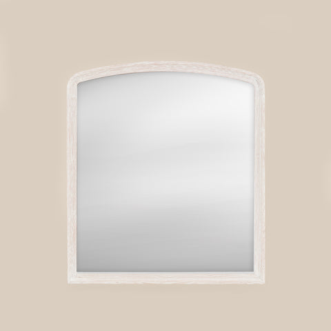 White wood framed over-mantel mirror on a beige wall
