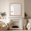 Cozy living room with a fireplace, over-mantel mirror, and decorative items.