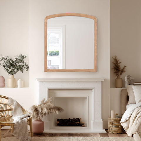 Cozy living room with a fireplace, over-mantel mirror, and decorative items.