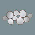Multi-circle bronze wall mirror with overlapping round forms, softly aged metallic framing and a contemporary sculptural feel.