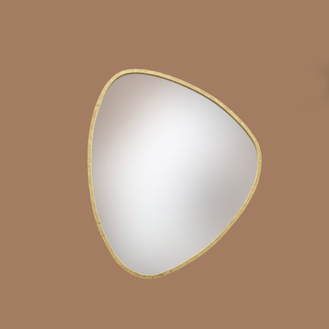 Triangular mirror with gold frame on a brown background