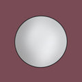 Round mirror with a black frame on a maroon background