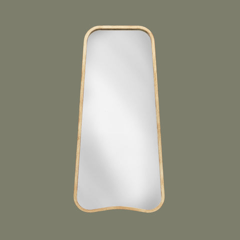 Rectangular organic shaped leaner mirror with gold effect frame on a light green background face on