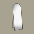 Black arch cheval mirror at an angle with a beige background