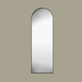 Black arch cheval mirror face on set in a  beige background