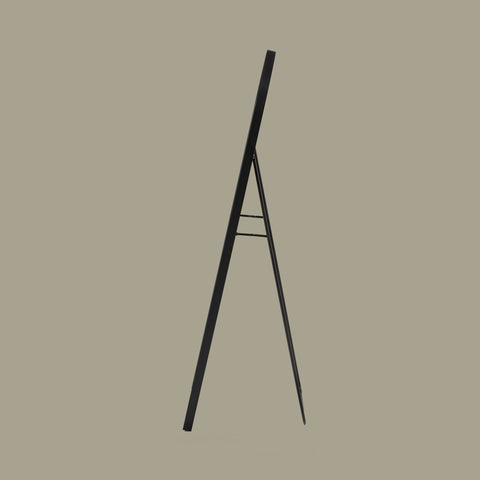 Black arch cheval mirror on a beige background