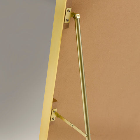 Back of a arched gold framed cheval mirror showing the stand arms