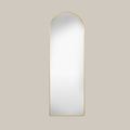 cheval arched mirror with gold frame on a beige background face on