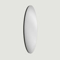 Elegant elongated oval mirror with a minimalist design, ideal for creating light and visual openness.