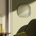 Rounded contemporary mirror styled within a warm interior, adding subtle dimension and elegant minimalist character.