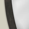 Close-up detail of a mirror frame featuring fine linear texture, curved shaping and subtle contemporary detailing.