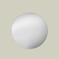 Modern round wall mirror showcasing a smooth reflective surface.