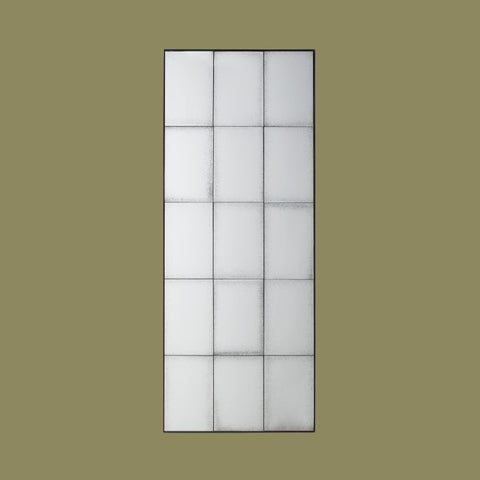 Vertical industrial-style wall mirror with antiqued glass panels and geometric black metal framing.