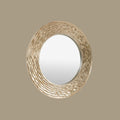 Textured round wall mirror featuring layered sculptural ridges, softly aged metallic tones and organic wave-inspired detailing.