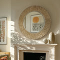 Serrano round wall mirror above fireplace in neutral living room