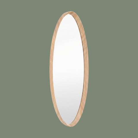 Oval wall mirror with a slim natural wood frame and minimalist contemporary design against a muted green background.