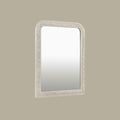 Traditional silver mirror with an intricately carved frame, showcasing decorative scroll detailing and softly rounded corners.