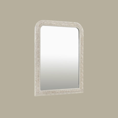 Traditional silver mirror with an intricately carved frame, showcasing decorative scroll detailing and softly rounded corners.