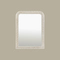 Traditional wall mirror featuring an intricately carved frame with elegant decorative detailing and softly rounded corners.