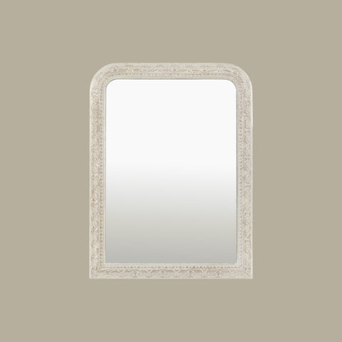 Traditional wall mirror featuring an intricately carved frame with elegant decorative detailing and softly rounded corners.