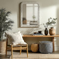 Decorative silver wall mirror with an ornate carved frame, styled above a wooden console table in a calm neutral interior for an elegant, timeless look.