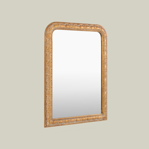 Gold-framed mirror with ornate carved detailing, designed to bring classic character and timeless elegance to interiors.