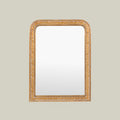 Decorative gold mirror with an ornate carved frame, showcasing intricate scroll detailing and a classic arched design.